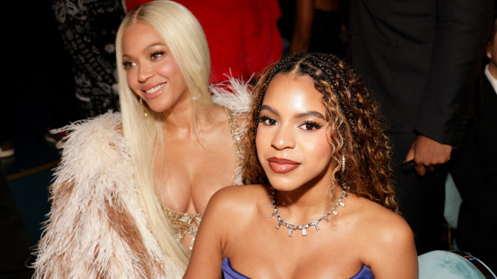 Beyonce-Blue-ivy Beyoncé smiles while sitting beside her daughter Blue Ivy Carter at a glamorous event.